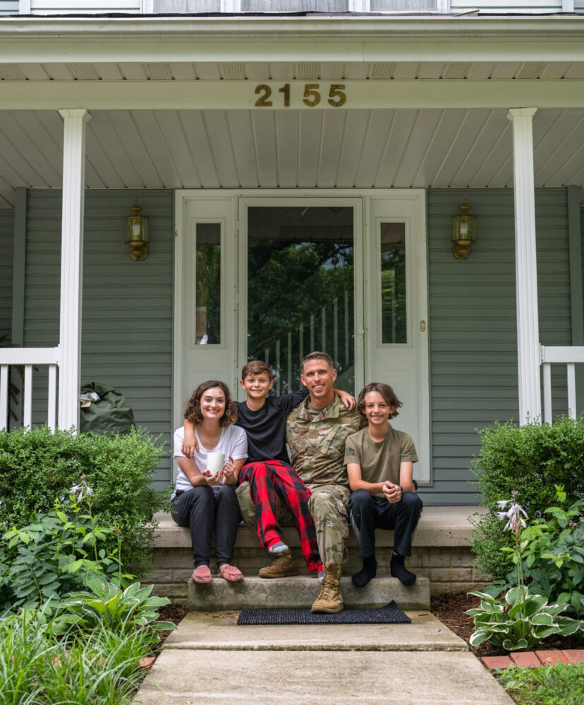Air Force service member poses with family for group photo.